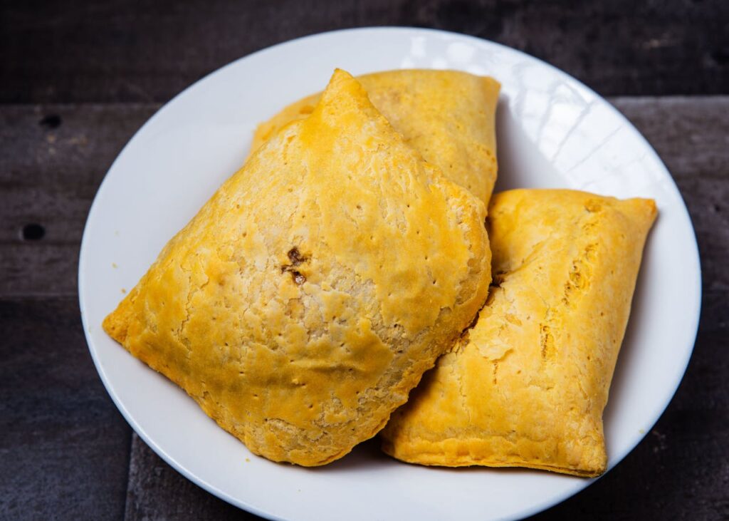 Home Delicious homemade Jamaican patties on a display plate, perfect for lunch or dinner.