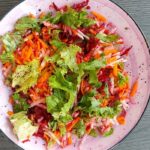 pexels photo 34287152 Colorful salad with fresh greens, carrots, beets, and radishes in a bowl.